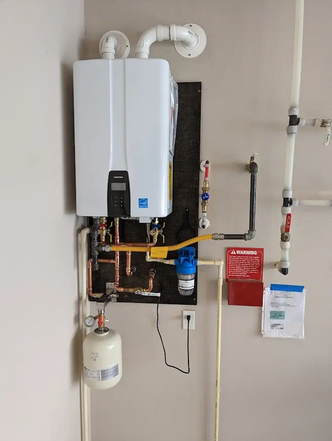 Professional plumber installing copper piping in a Whiteville home